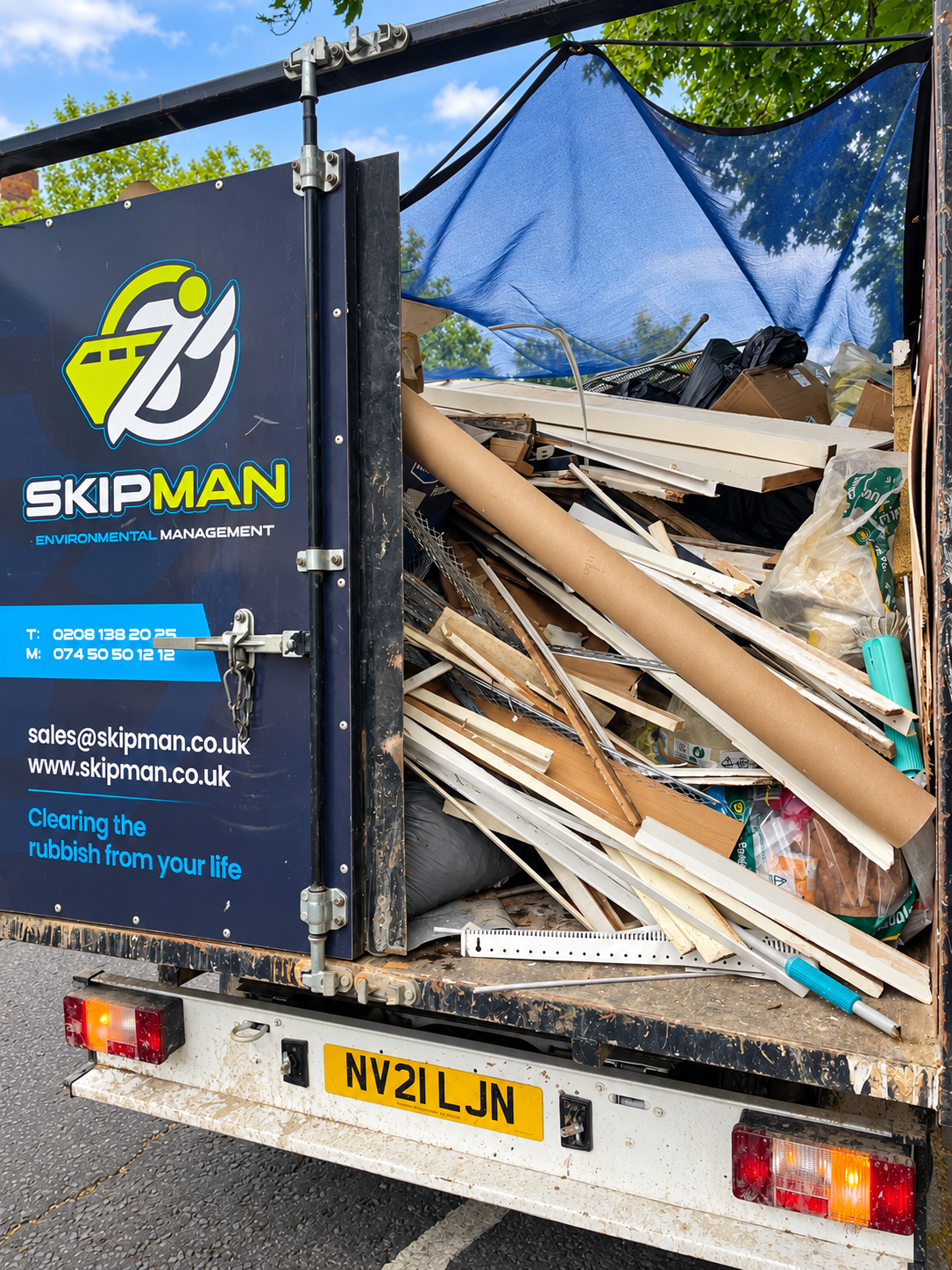 SKIPMAN cage van loaded with refurbishment waste in Ruislip