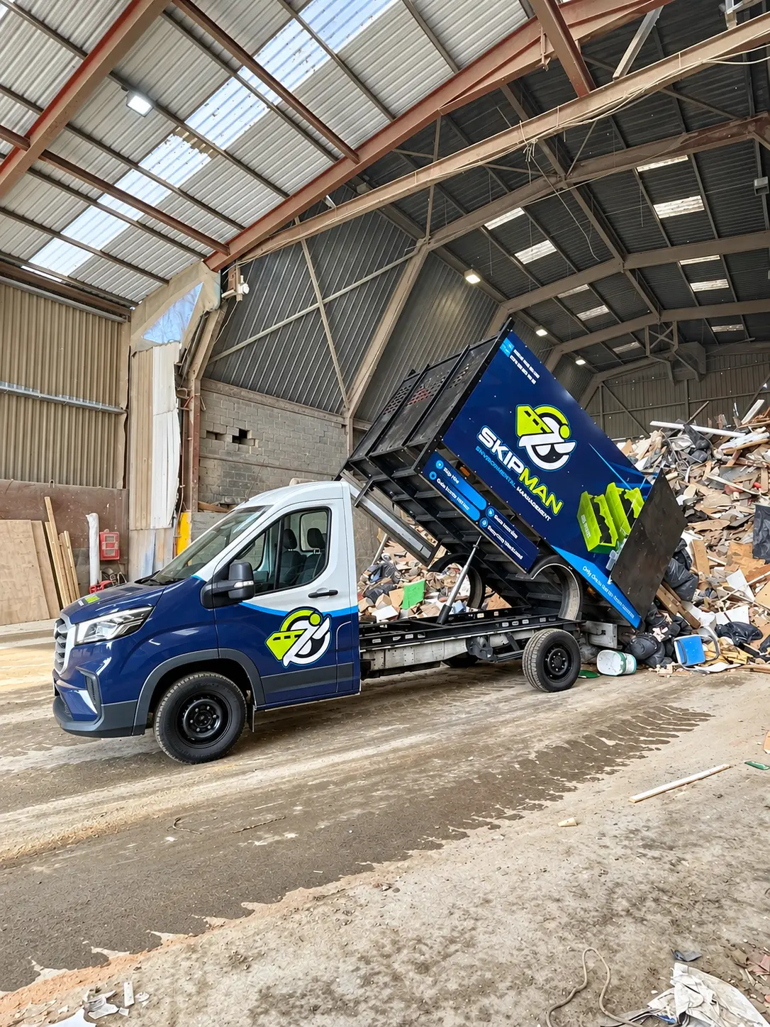 SKIPMAN cage van unloading at a waste transfer station