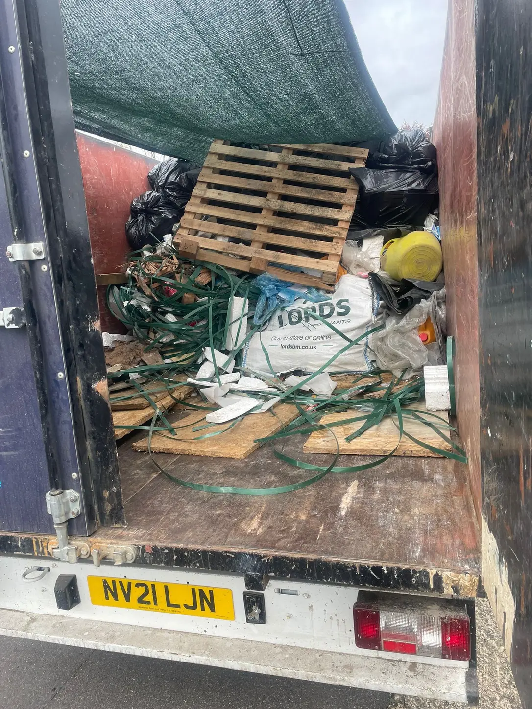 Bagged waste and pallets loaded into the SKIPMAN cage van